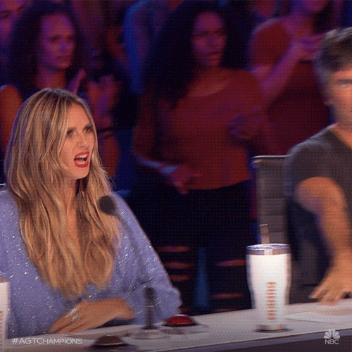 Heidi Klum brings her hands to her face in a horrified gasp and shields her eyes